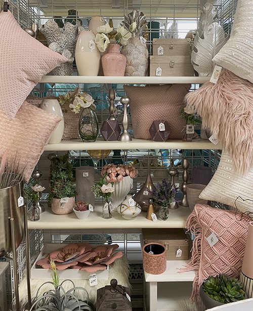 shelves of pink glass vases and decorations